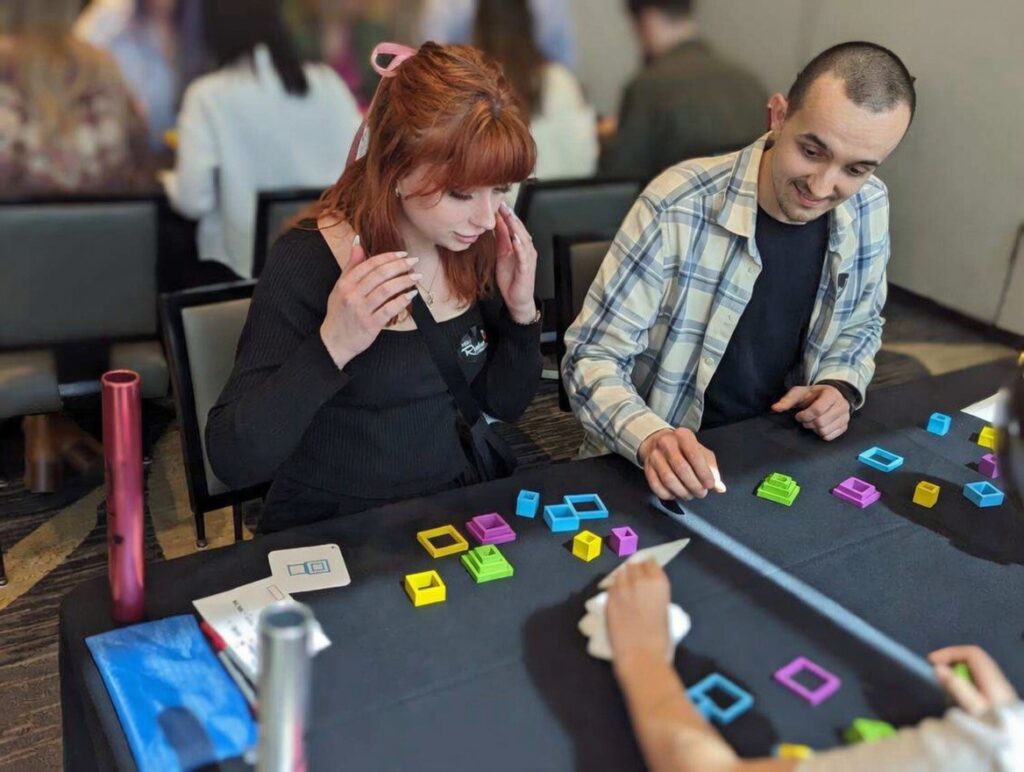 man and woman engaged with different colored squares during a workplace assessment